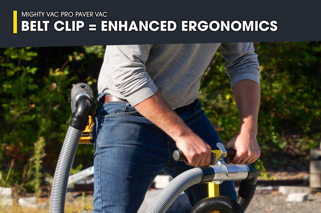 Person using a Mighty Vac Pro Paver Vac with a belt clip for enhanced ergonomics, outdoors.