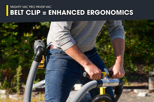 Person using a Mighty Vac Pro Paver Vac with a belt clip for enhanced ergonomics, outdoors.