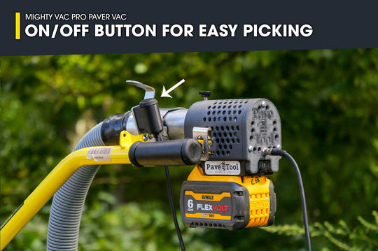 Mighty Vac Pro Paver Vac with on/off button for easy picking, against a blurred green background.