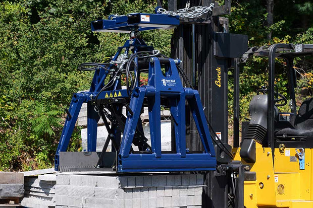 Blue forklift attachment on a yellow forklift with trees in the background