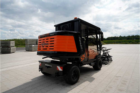 An orange and black S24 PaveJet paver laying machine with a black cabin