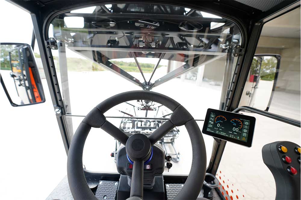 An orange and black S24 PaveJet paver laying machine - interior cabin